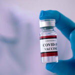 Close,Up,A,Vial,Of,Covid-19,Vaccine,In,Hand,Of