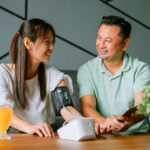 Mature couple measuring blood pressure at home